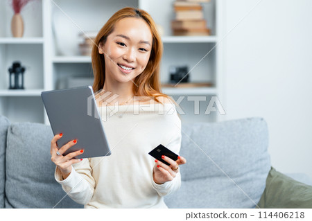 Happy Young Woman Using Tablet And Smartphone At Home Happy Young Woman Using Tablet And Smartphone At Home 114406218
