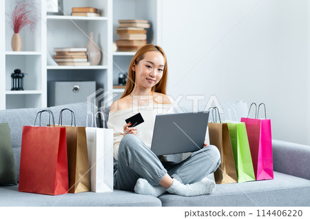 Young Woman Shopping Online With Credit Card And Laptop 114406220