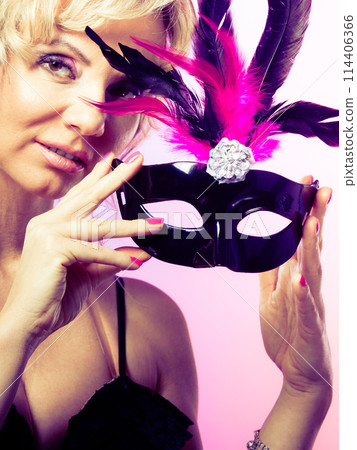Woman middle aged holds carnival mask. Woman middle aged holds carnival mask. 114406366