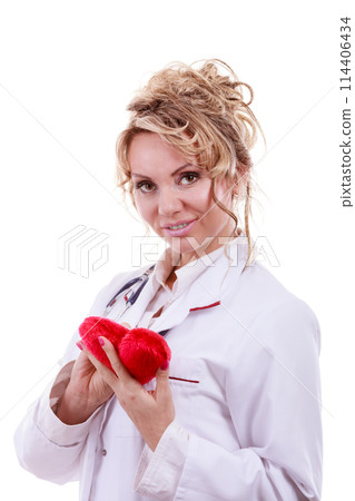 Doctor with stethoscope examining red heart. 114406434