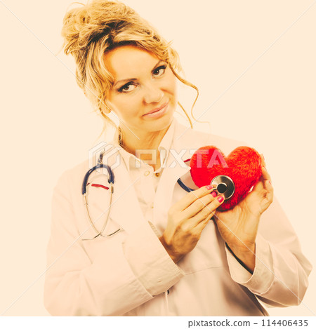 Doctor with stethoscope examining red heart. Doctor with stethoscope examining red heart. 114406435