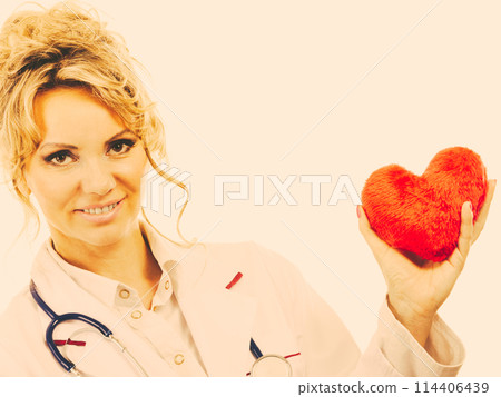 Female cardiologist with red heart. Female cardiologist with red heart. 114406439