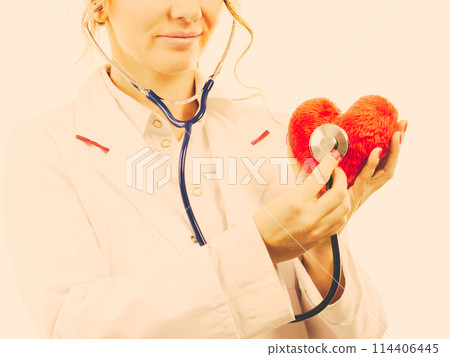Doctor with stethoscope examining red heart. 114406445