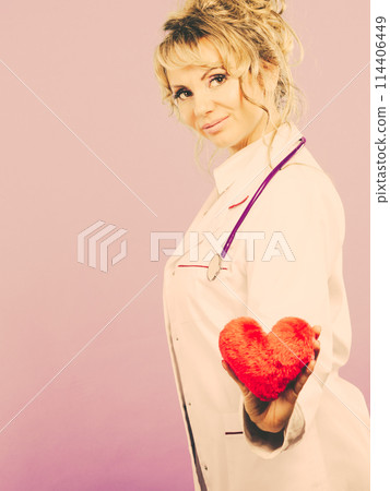 Middle aged blonde doctor enjoy her work. Middle aged blonde doctor enjoy her work. 114406449