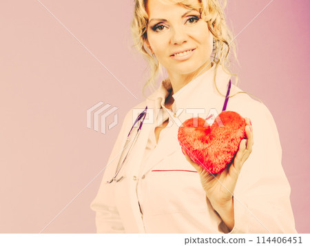 Middle aged blonde doctor enjoy her work. Middle aged blonde doctor enjoy her work. 114406451