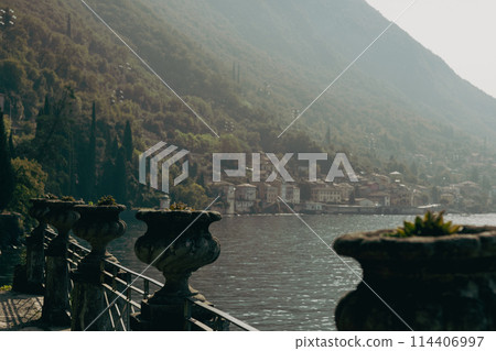 Big ornamental plant pot vase. Vases of succulent decorated with architectural elements on a sunny day. Villa Monastero, Botanical garden 114406997