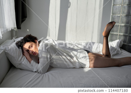 handsome sexy man rests on bed with raised led 114407180