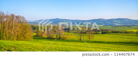 A breathtaking view of the Jested Ridge horizon, captured from a lush green field under a clear blue sky. The serene atmosphere suggests early morning or late afternoon. Located in Czech Republic A breathtaking view of the Jested Ridge horizon, captured from a lush green field under a clear blue sky. The serene atmosphere suggests early morning or late afternoon. Located in Czech Republic 114407674
