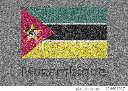 The Mozambican flag painted on a stone slab with the word "Mozambique" carved into it 114407917