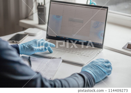 modern lab environment with a laptop, gloved hands, and handwritten notes. The use of technology alongside paper and pen suggests a contemporary approach to lab work modern lab environment with a laptop, gloved hands, and handwritten notes. The use of technology alongside paper and pen suggests a contemporary approach to lab work 114409273