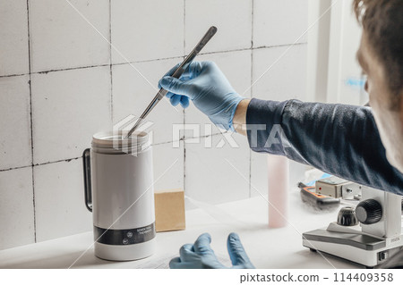 advanced equipment in a laboratory, including a microscope and a semen thaw thermostat, illustrating the innovative processes in biochemistry and biotechnology 114409358