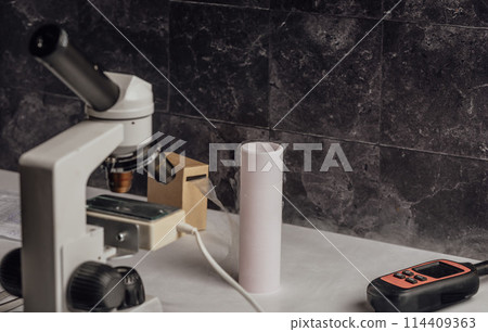 lab setup dedicated to the study of animal reproduction, featuring a microscope and liquid nitrogen tank crucial for storing biological specimens 114409363