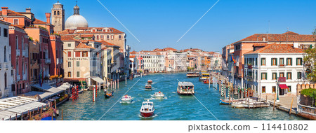 Grand canal with boat and gondola in Venice city, Italy, horizontal view. Medieval european architecture. Grand canal with boat and gondola in Venice city, Italy, horizontal view. Medieval european architecture. 114410802