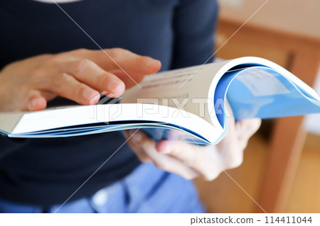 Hands of a woman reading a book Hands of a woman reading a book 114411044