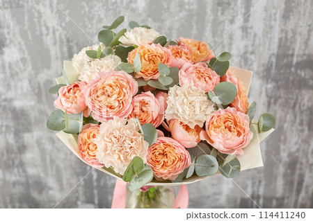 Small Beautiful bouquet of mixed flowers in woman hand. Floral shop concept . Beautiful fresh cut bouquet. Flowers delivery Small Beautiful bouquet of mixed flowers in woman hand. Floral shop concept . Beautiful fresh cut bouquet. Flowers delivery 114411240