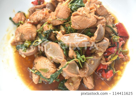 spicy chili stir-fried chicken meat and gizzard couple liver with basil leaf on plate 114411625