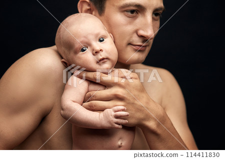 serious guy holding a nude baby serious guy holding a nude baby 114411830