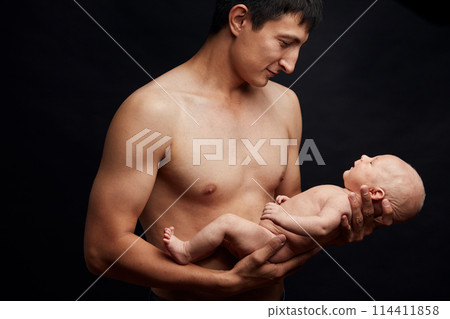young handsome man holding his son for the firsst time. fist meeting. 114411858