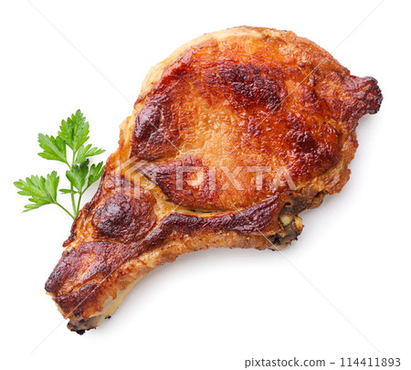 Fried pork loin with parsley leaf on a white background. Top view 114411893