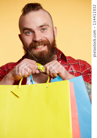 Bearded man, long beard. Brutal caucasian with moustache holding shopping packages 114411932
