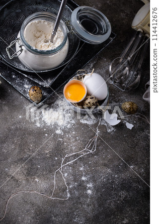 Baking ingredients with flour and eggs 114412676
