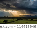 Rays of light shining through dark clouds It's goanna rain. 114413946