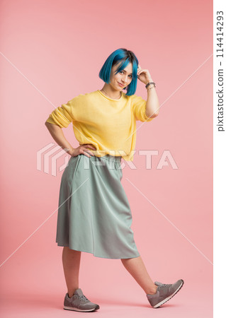 smiling attractive girl demonstrating retro style in clothes smiling attractive girl demonstrating retro style in clothes 114414293