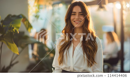 Smiling woman in white blouse poses in a sunlit room. Casual style, lifestyle portrait. Natural light photography, modern feeling. AI 114414406