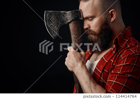 lumberjack. Confident bearded man attached to forehead axe 114414764