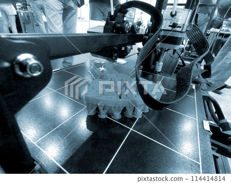 Abstract object printing on 3D printer with molten plastic close-up. 3D printer printing model melted plastic. 3D Prototyping. 3D design. Additive printer technology. New modern printing technology 114414814