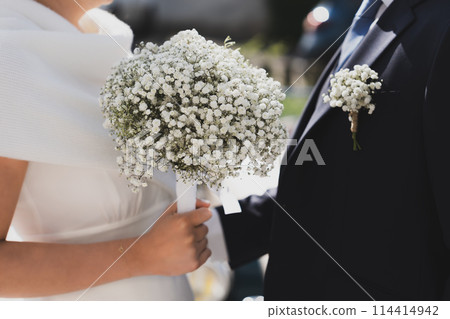 Bridal bouquet and a groom boutonniere of Gypsophila 114414942