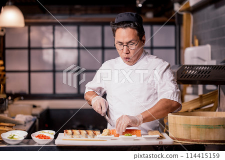 young Japanese man is nervouse about cutting the roll young Japanese man is nervouse about cutting the roll 114415159