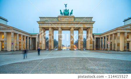 Twilight descends on Brandenburg Gate, with soft lighting illuminating the historic arch and the Quadriga statue atop. Berlin, Germany Twilight descends on Brandenburg Gate, with soft lighting illuminating the historic arch and the Quadriga statue atop. Berlin, Germany 114415527