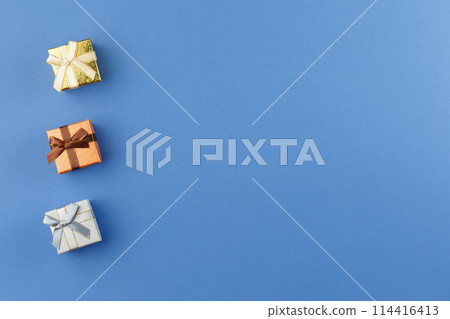 Present in gift paper on the table. 114416413