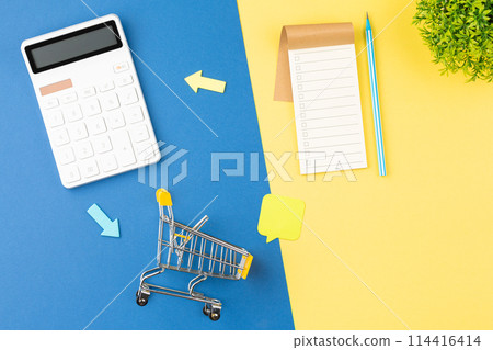 Calculator with supermarket trolley and notepad. 114416414