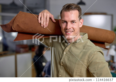 cheerful happy handsome master has idea for new leather products. 114416637