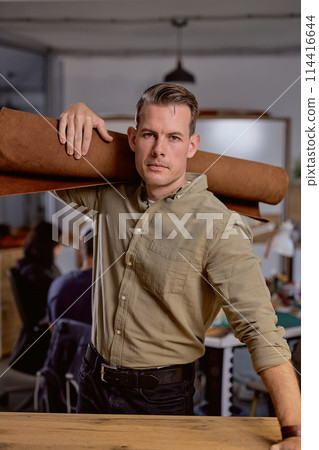handsome crafter is ready to make leather items 114416644