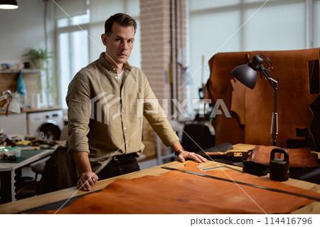 handsome cobbler looking at the camera 114416796