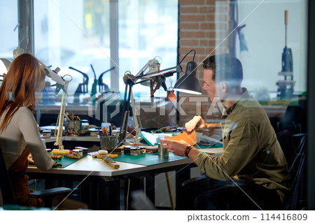 young active craftsman and craftswoman working in the workshop young active craftsman and craftswoman working in the workshop 114416809