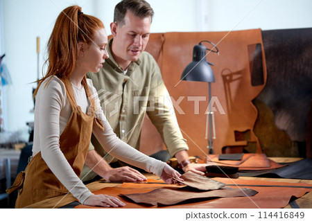 ginger girl teaching her male student to sew handmade goods ginger girl teaching her male student to sew handmade goods 114416849