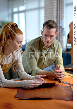 serious man and ginger woman thinking how to add a unique design 114416869