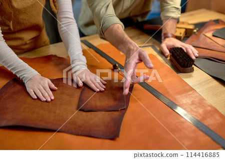 man pointing to cut leather man pointing to cut leather 114416885