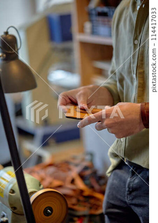 craftsman uses a bench grinder at studio craftsman uses a bench grinder at studio 114417033