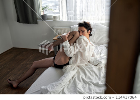 crazy man in fishnets spends time in the bedroom 114417064