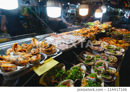 A stall with various delicacies at the night market in Vietnam A stall with various delicacies at the night market in Vietnam 114417106