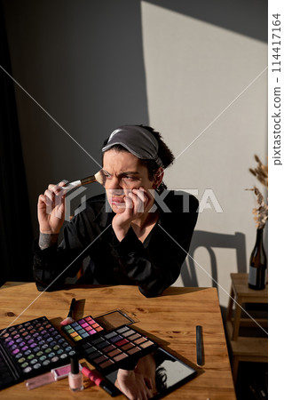 angry man in fashion bathrobe wears make up 114417164