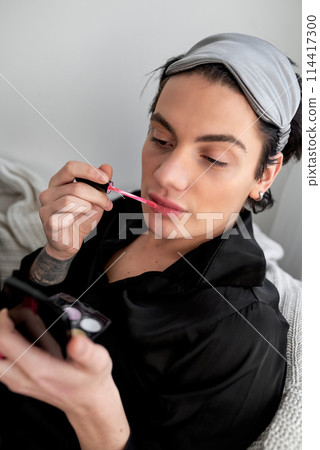 young glamour man using lipstick young glamour man using lipstick 114417300