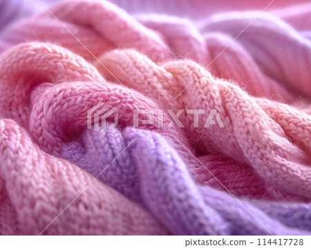 Detailed photograph emphasizing the thick, soft strands of a pink and purple blanket. Detailed photograph emphasizing the thick, soft strands of a pink and purple blanket. 114417728