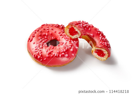 Red glazed donuts with berry jelly filling and sprinkles 114418218