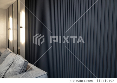 Modern living room interior with grey wooden slats and ice lamps on the wall. 114419592